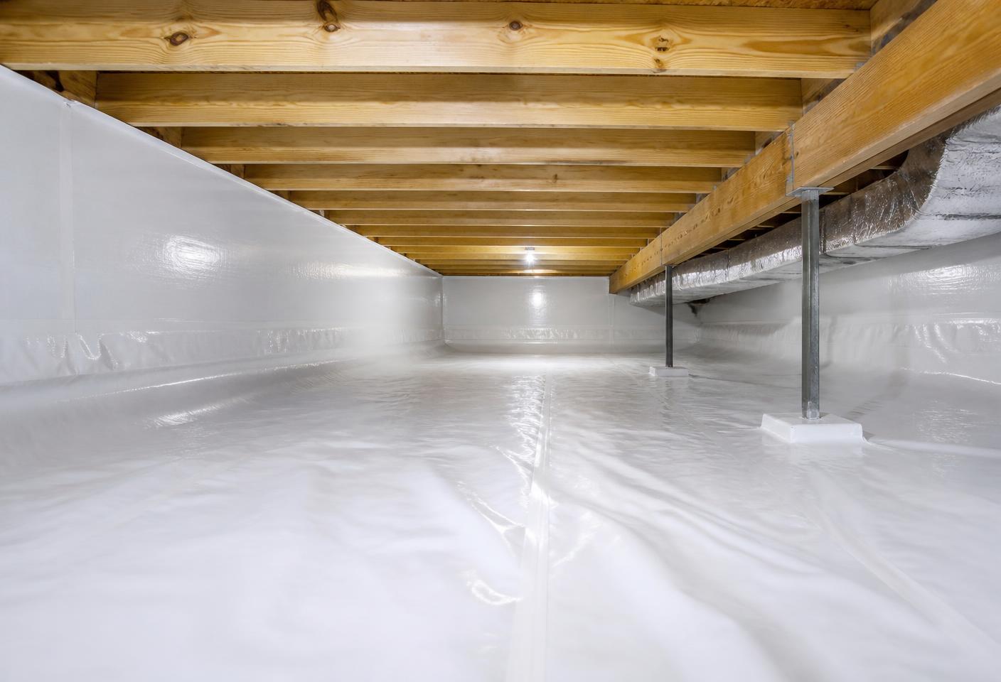 Crawl space with white reinforced liner covering the ground and running up the foundation walls